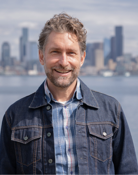 Alex Meyer Portrait of partner and field operations manager Ian Franks with the Seattle skyline in the background