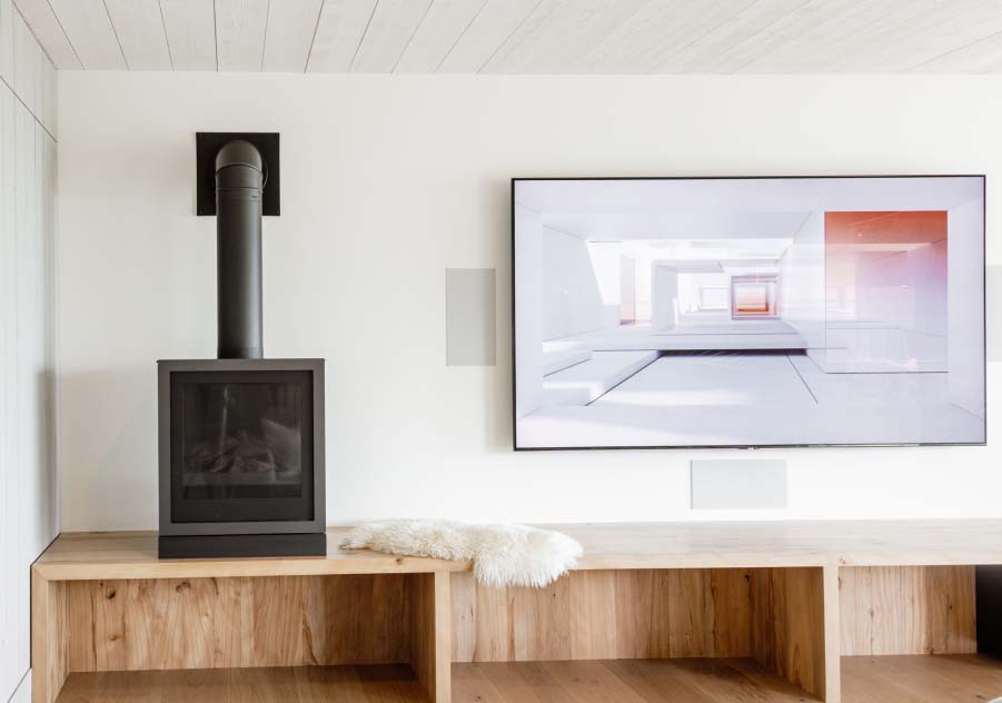 Blue Ridge ADU living room with built-in shelving and wood stove